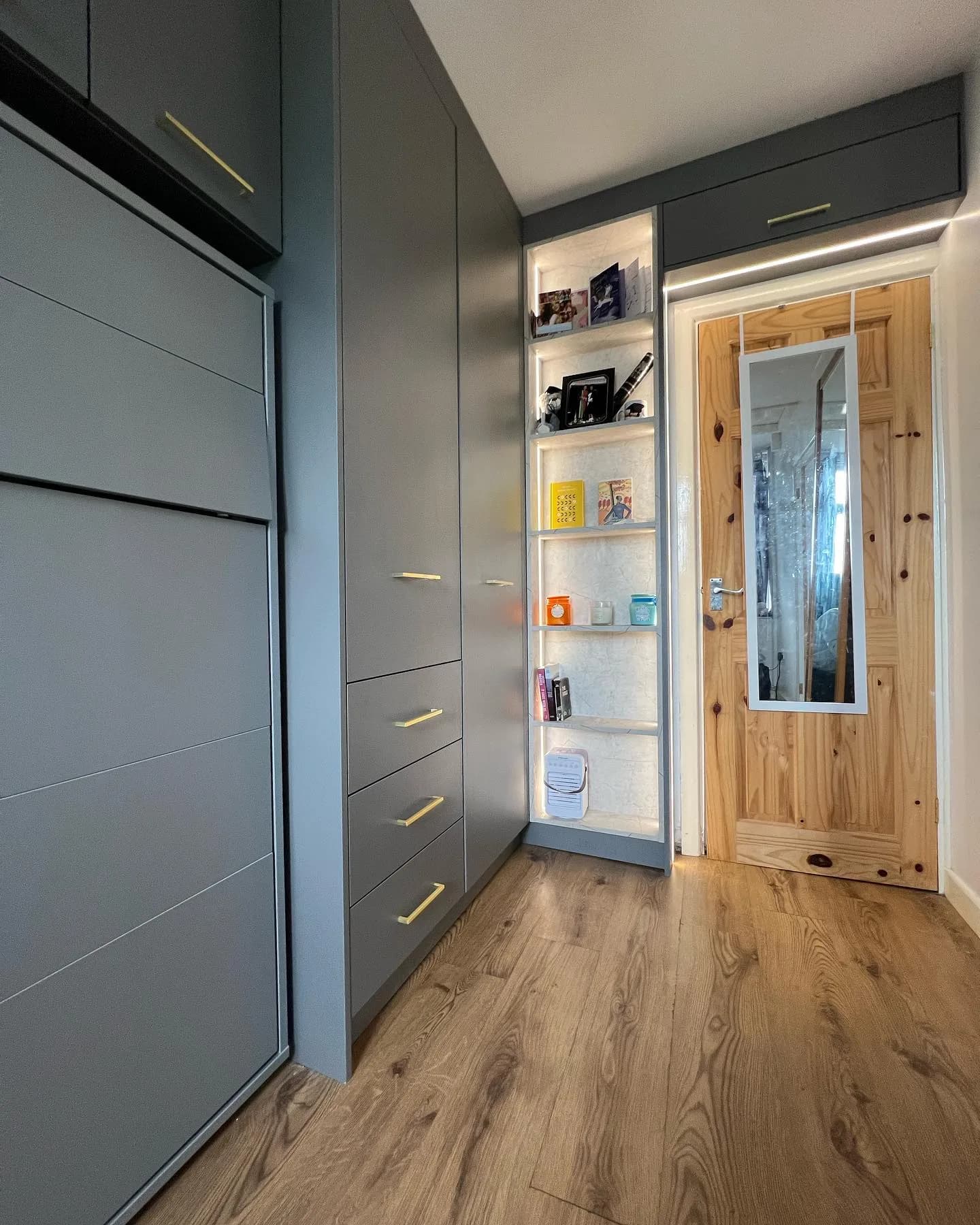 Matt grey fitted wardrobes with lit marble-backed display niches, real installation