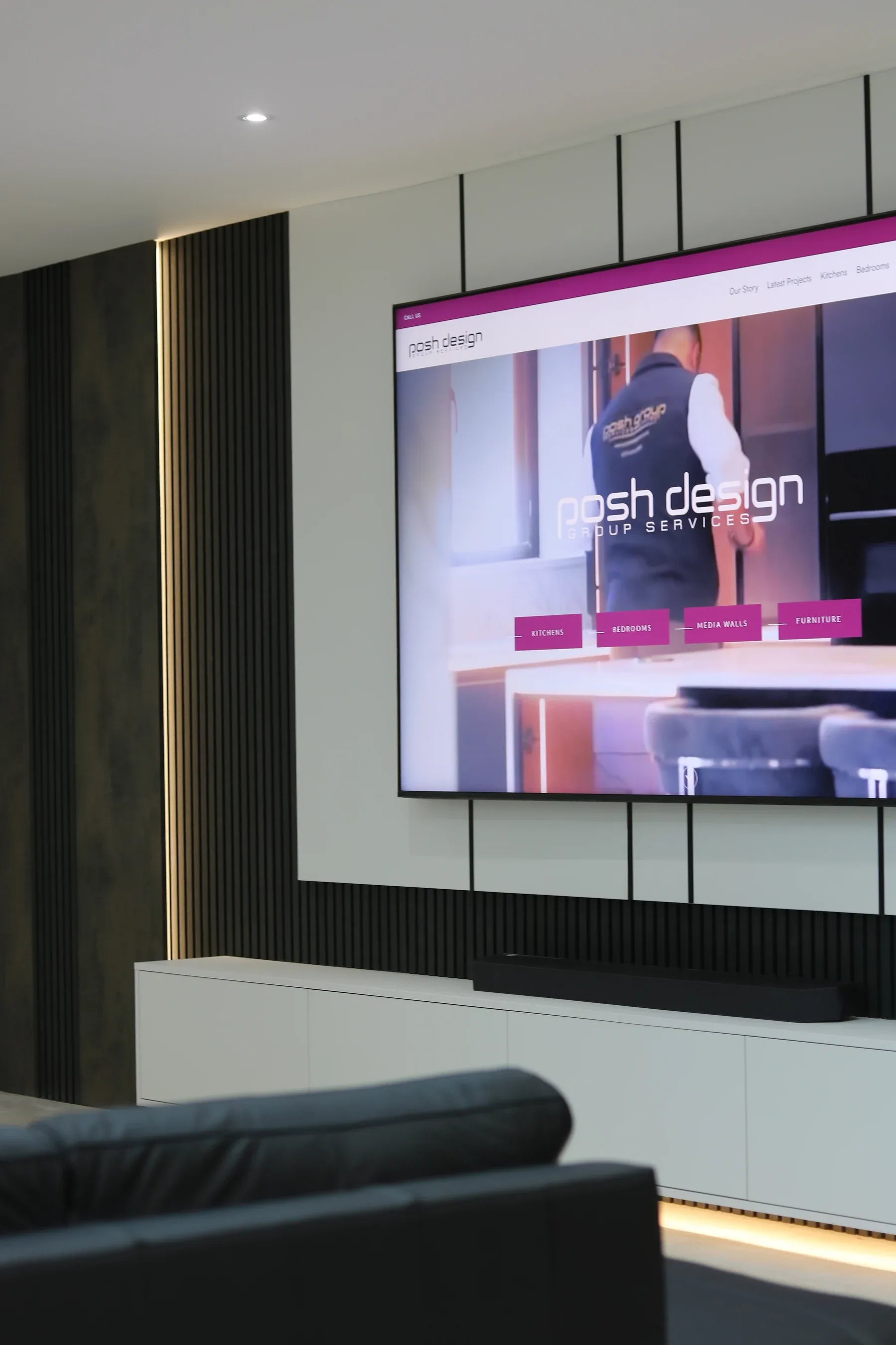 Dark fluted media wall with recessed television, real installation