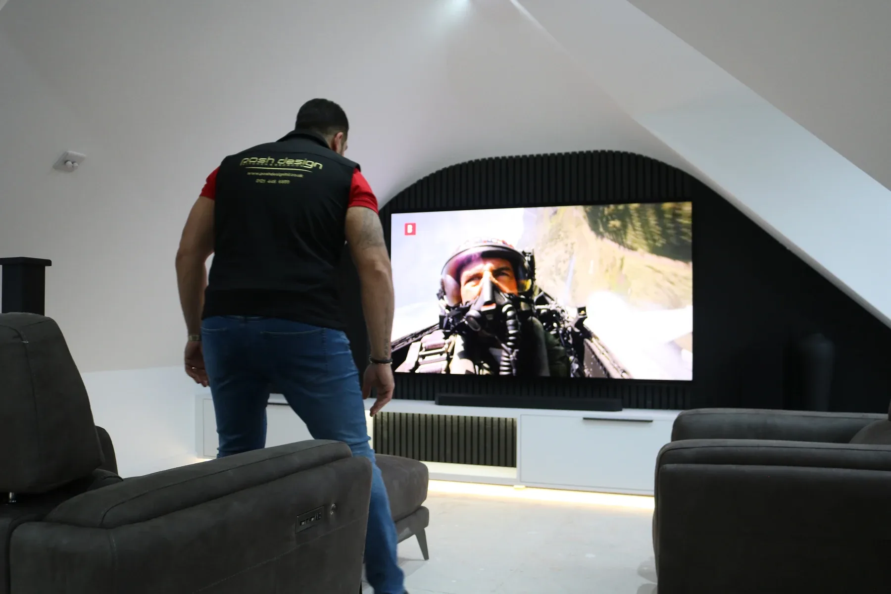 A Bespoke Bedrooms fitter installing a home cinema wall